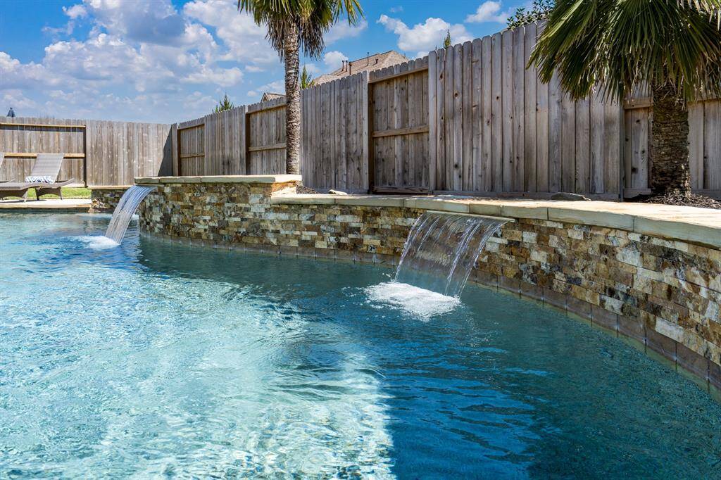 Ahhh! Nothing better than the soothing sound of waterfalls to help you relax in this amazing pool!