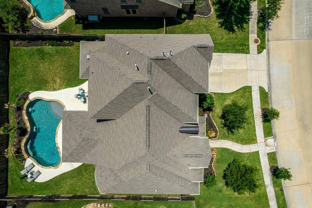This bird's eye view showcases the sparkling pool, large deck and patio area, and abundant green space. At 16902 East Caramel Apple Trail, your dream home awaits!