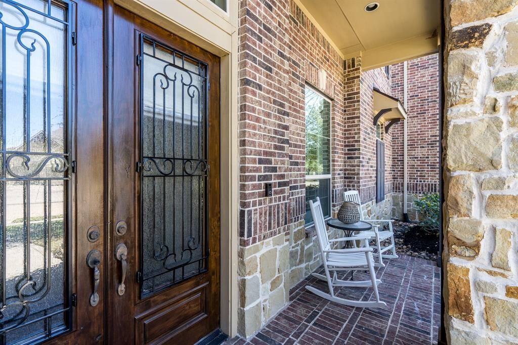 A quaint, covered porch offers a place to sit, relax and enjoy a morning cup of coffee.