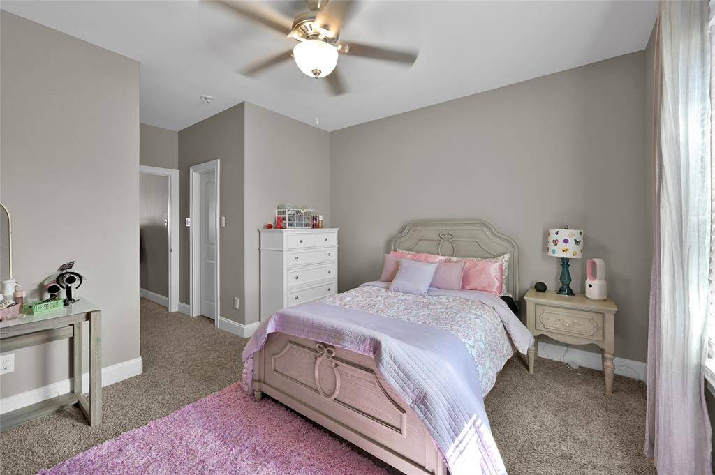Another photo of this great bedroom.  The closets are all walk in closets and every bedroom has their own en-suite bath. This cozy bedroom features a soft color palette. It features a  ceiling fan, and ample natural light.