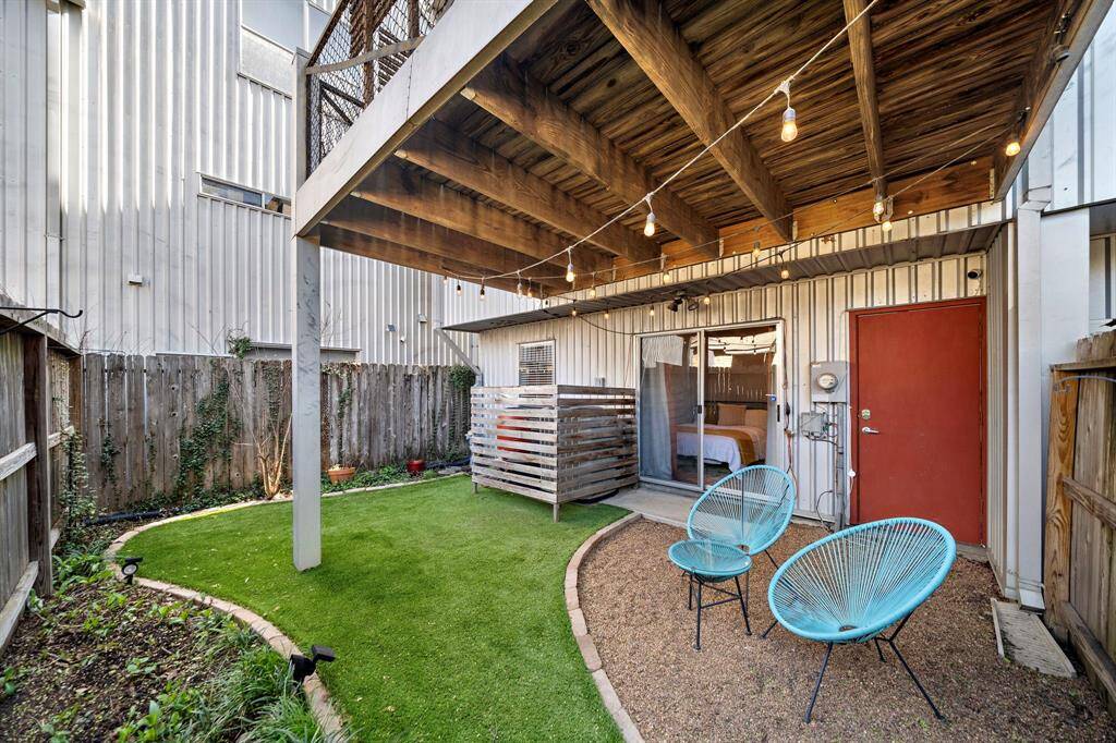 The darling backyard with artificial turf and beds for gardening or planting (more photos of the yard at the end).