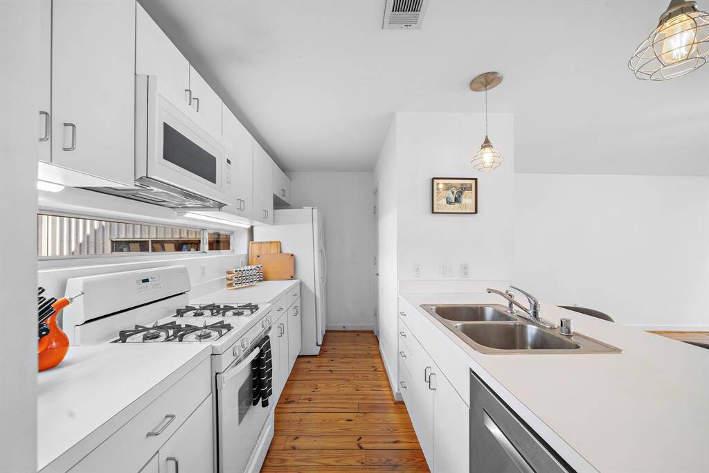 Functional kitchen with windowed backsplash for more light.
