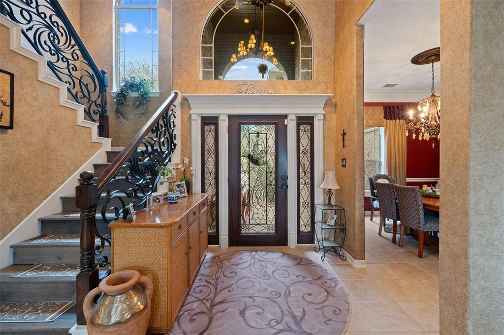 STUNNING FOYER FOR YOUR GUESTS ENTRY, IMPORTED WOODWORK USED ON THE STAIRCASE AND UPSTAIRS FLOOR
