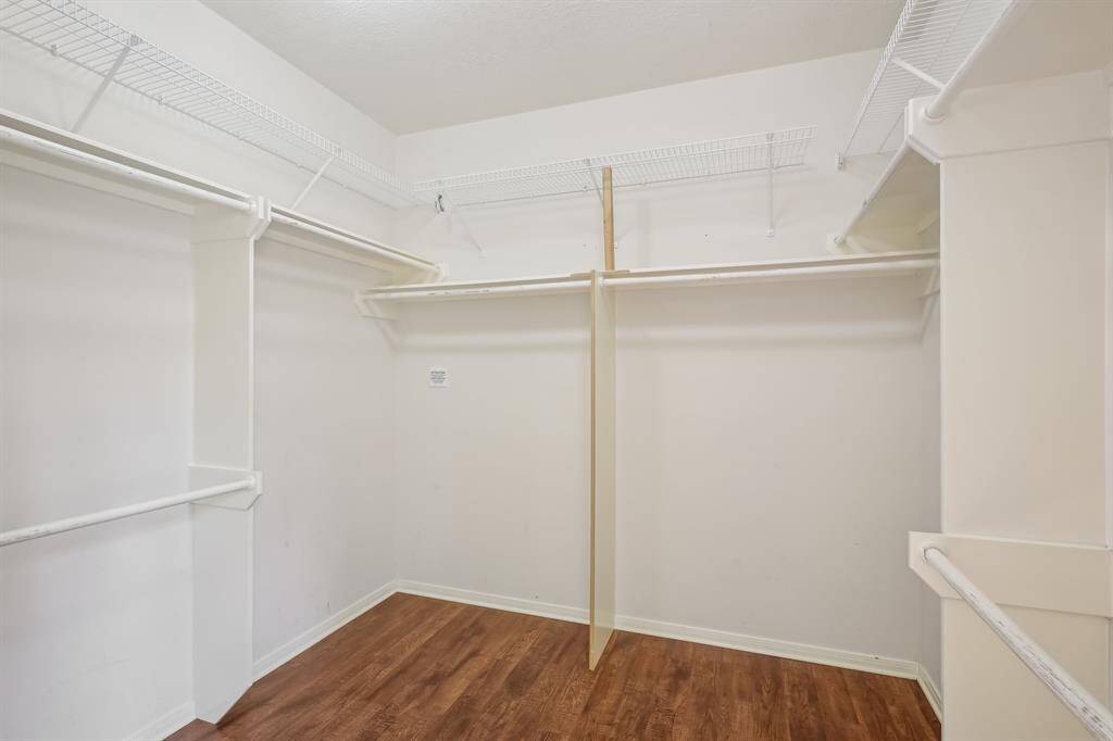 Expansive primary closet with ample storage space.