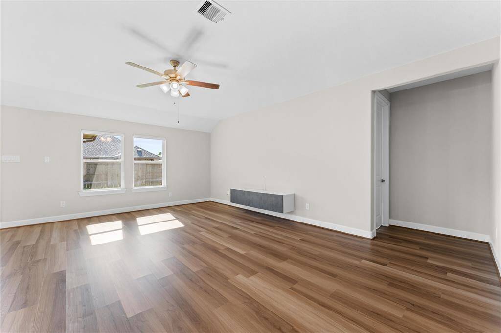 The primary bedroom is a peaceful retreat, offering a generous layout that invites rest and relaxation. Large windows fill the space with soft, natural light, creating a serene atmosphere.