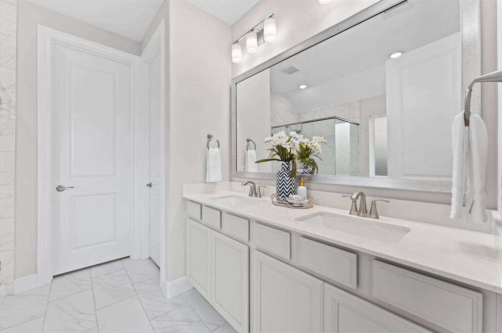 A true retreat, the primary bathroom offers a spa-like experience with thoughtful design and elegant finishes. The double vanities provide plenty of space for two, making mornings effortless.