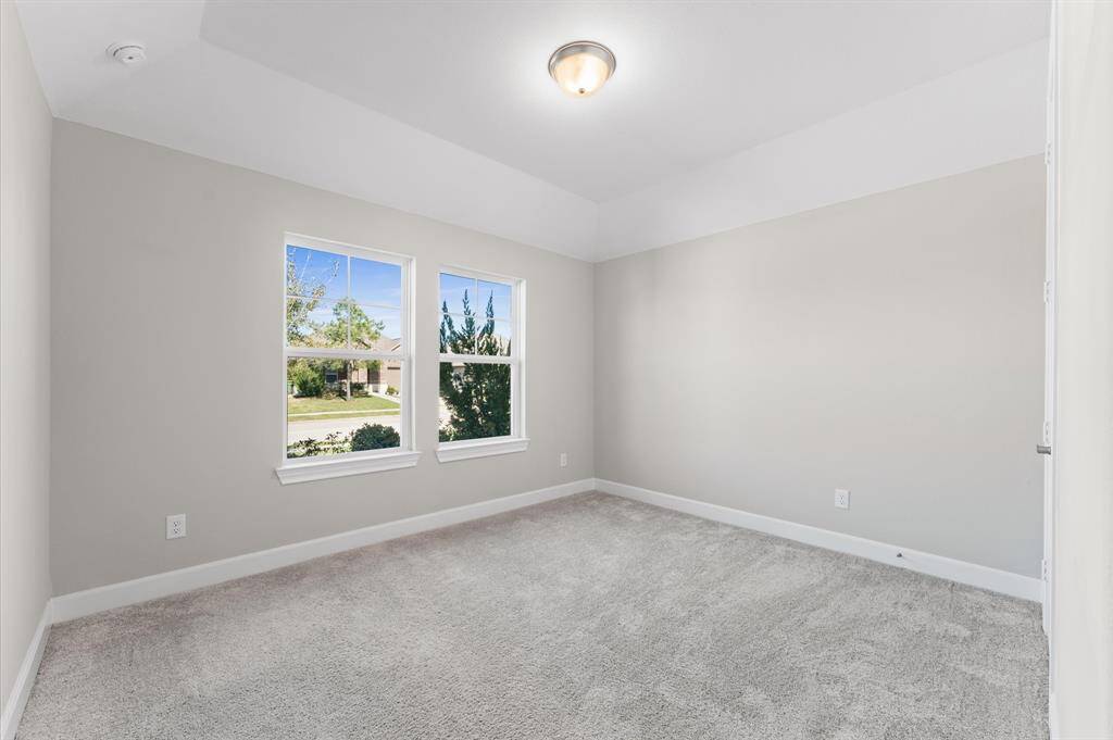 Tucked away for extra privacy, the fourth bedroom is perfect for guests or family members looking for their own peaceful corner. Its cozy ambiance makes it an ideal spot to recharge.