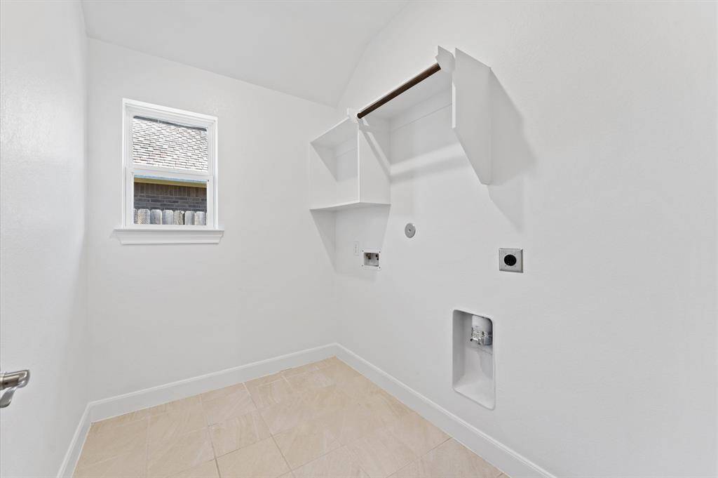 The laundry room adds everyday ease with plenty of space to keep things organized and tidy. Located for convenience, it helps make household tasks a breeze.