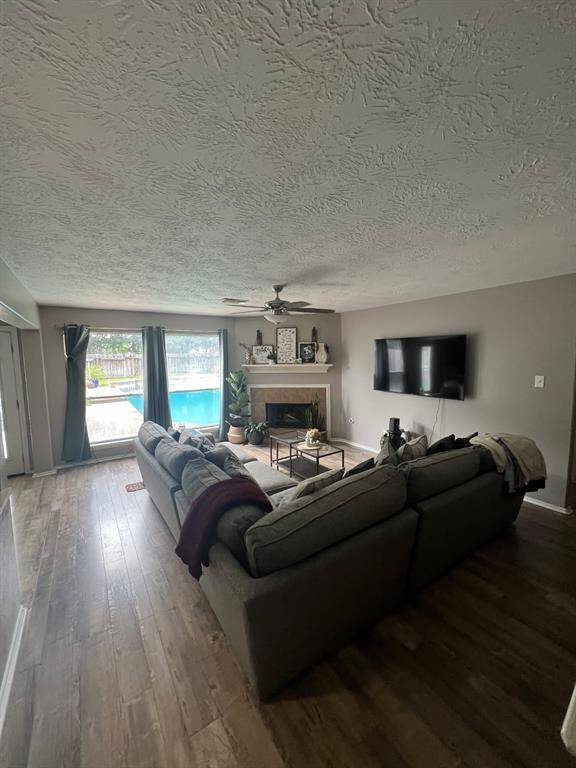 Large living room with views of the pool and open to kitchen.