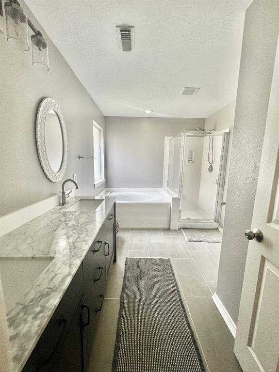 Main bathroom has separate tub and shower with large walk-in closet.