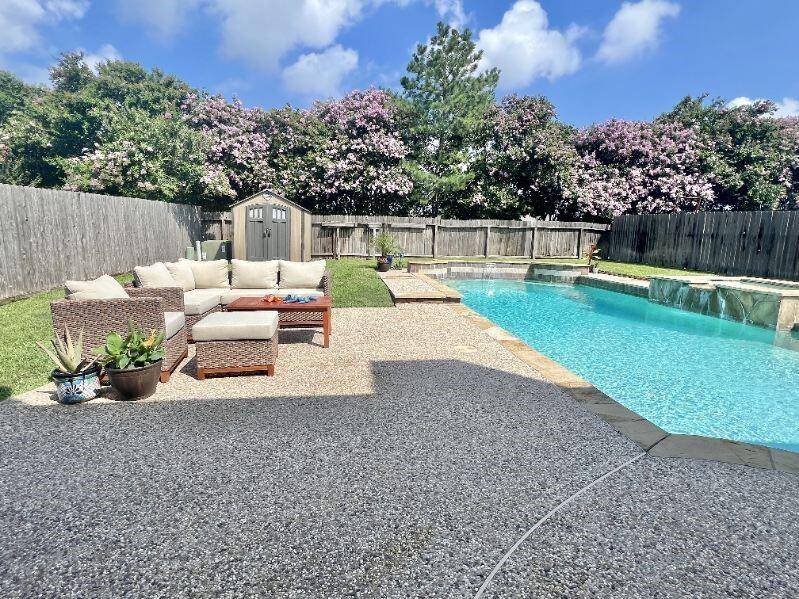 Huge backyard complete with pool, plenty of grass, and spacious patio.