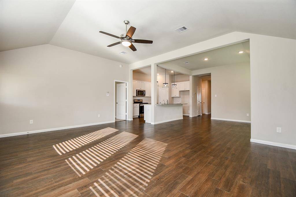 Stunning hardwood floors elevate the living room's elegance.