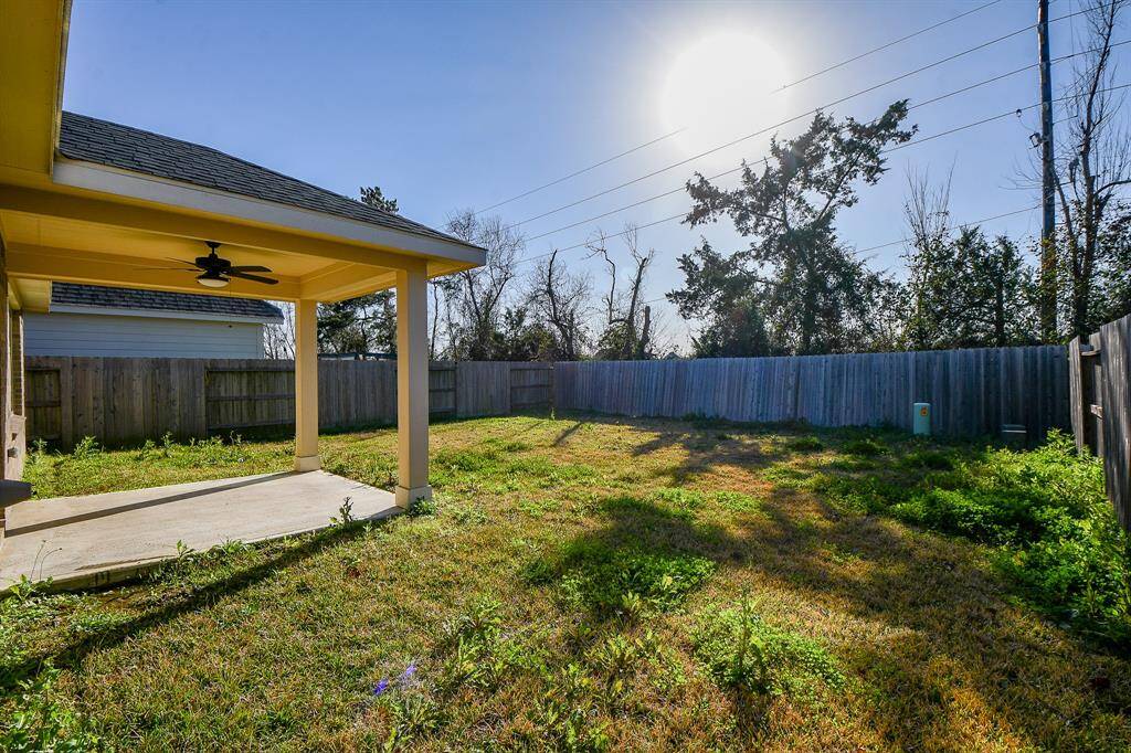 Discover the perfect retreat on a breezy back patio with a ceiling fan, ideal for relaxing or entertaining.