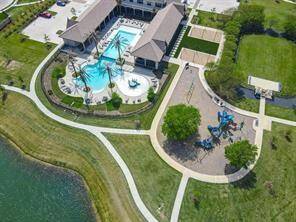 A breathtaking aerial view showcases the elegant clubhouse and shimmering pool, perfect for relaxation and social gatherings.
