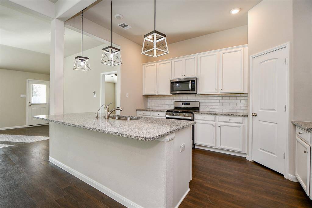 Experience the allure of this spacious island kitchen, ideal for cooking and entertaining.