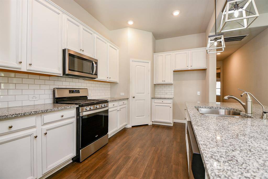 Elegant kitchen with abundant cabinetry and expansive countertops.