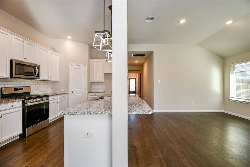 Spacious dining area seamlessly connects with the living room and kitchen.
