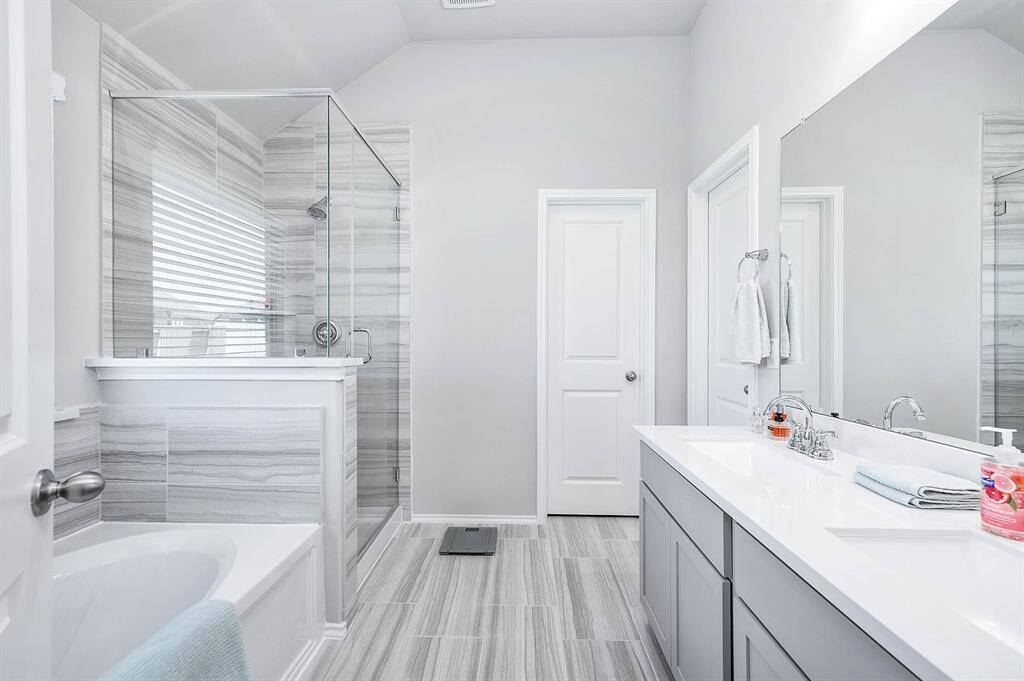 Gorgeous Primary Bathroom with double-sinks and separate shower and tub.