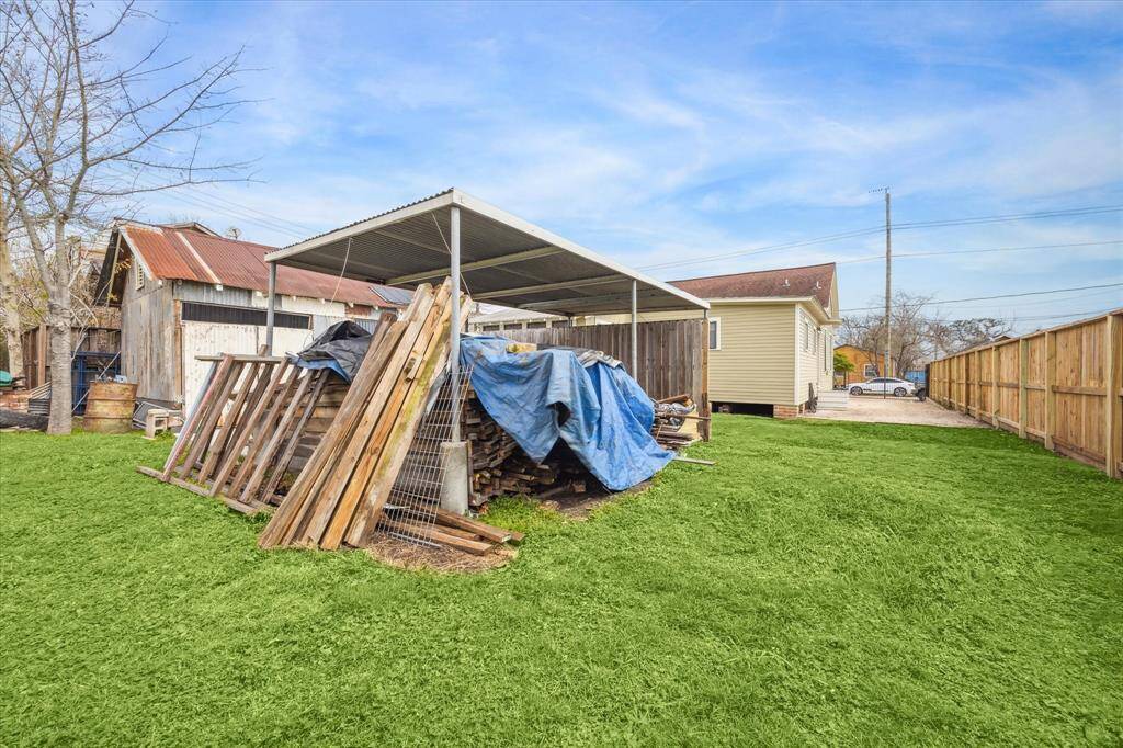 This carport and shed are included.  The property line ends where the tree stands