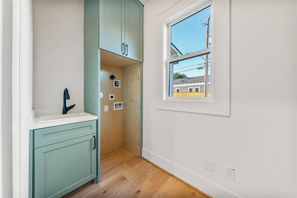 A spacious and well-designed secondary first-floor laundry room, making daily routines effortless and organized.
