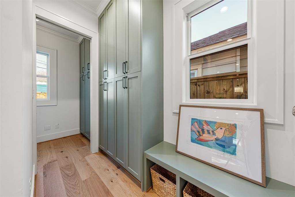 With custom built-in cabinetry, off of this first-floor laundry area, the mudroom offers the perfect blend of storage and style.