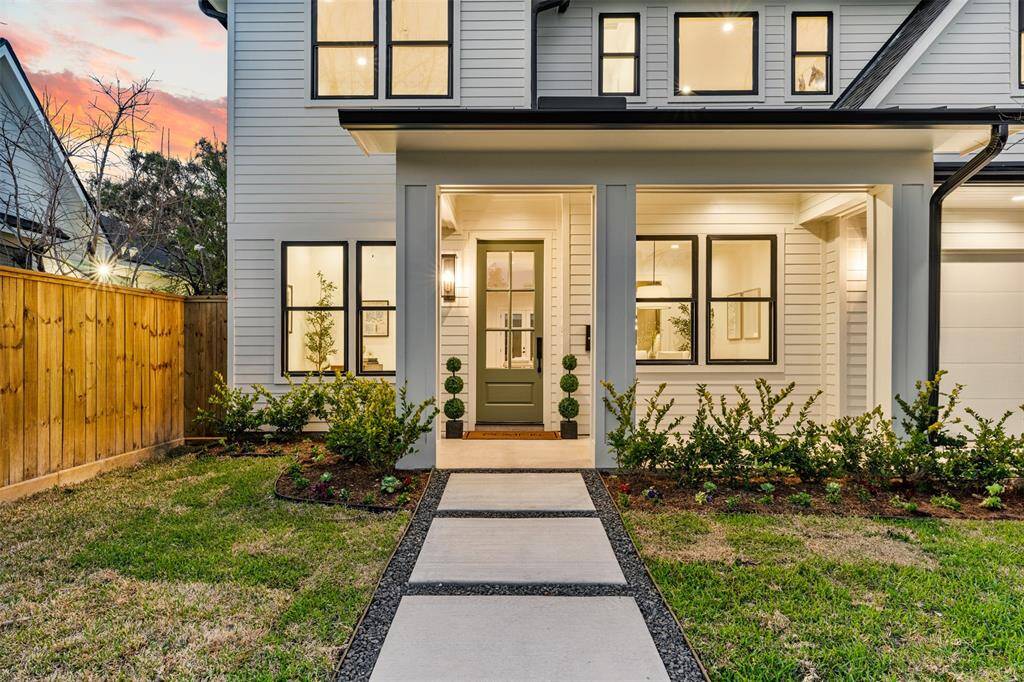 A grand entrance! The beautifully landscaped walkway sets the stage for this stunning Modern Prairie home.