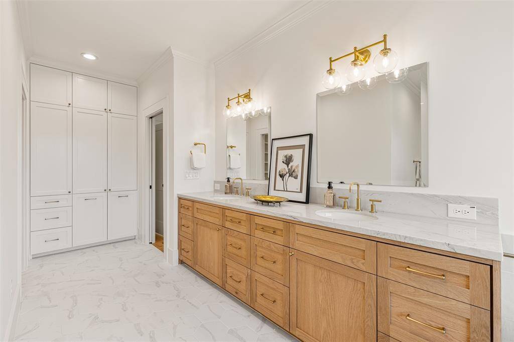 Every detail in the primary bath exudes luxury, from the elegant quartzite countertops to the serene, spa-inspired finishes.