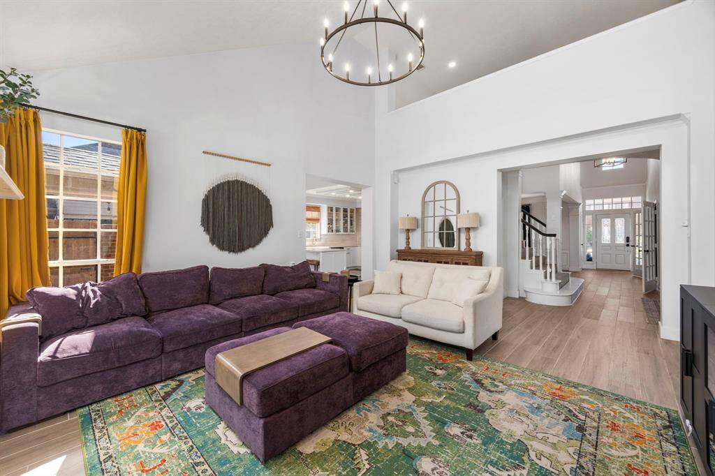 This custom kitchen is a show-stopper! Fully gutted and renovated, this new configuration features a bar, glass-front cabinets, SS appliances, and gorgeous tile flooring.
