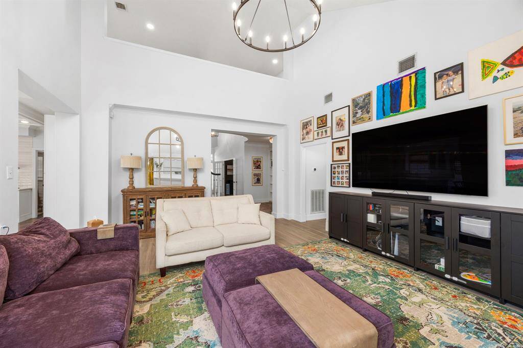 This custom kitchen is a show-stopper! Fully gutted and renovated, this new configuration features a bar, glass-front cabinets, SS appliances, and gorgeous tile flooring.