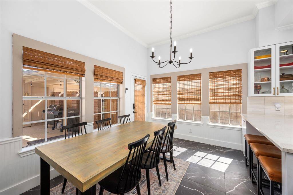 This custom kitchen is a show-stopper! Fully gutted and renovated, this new configuration features a bar, glass-front cabinets, SS appliances, and gorgeous tile flooring.
