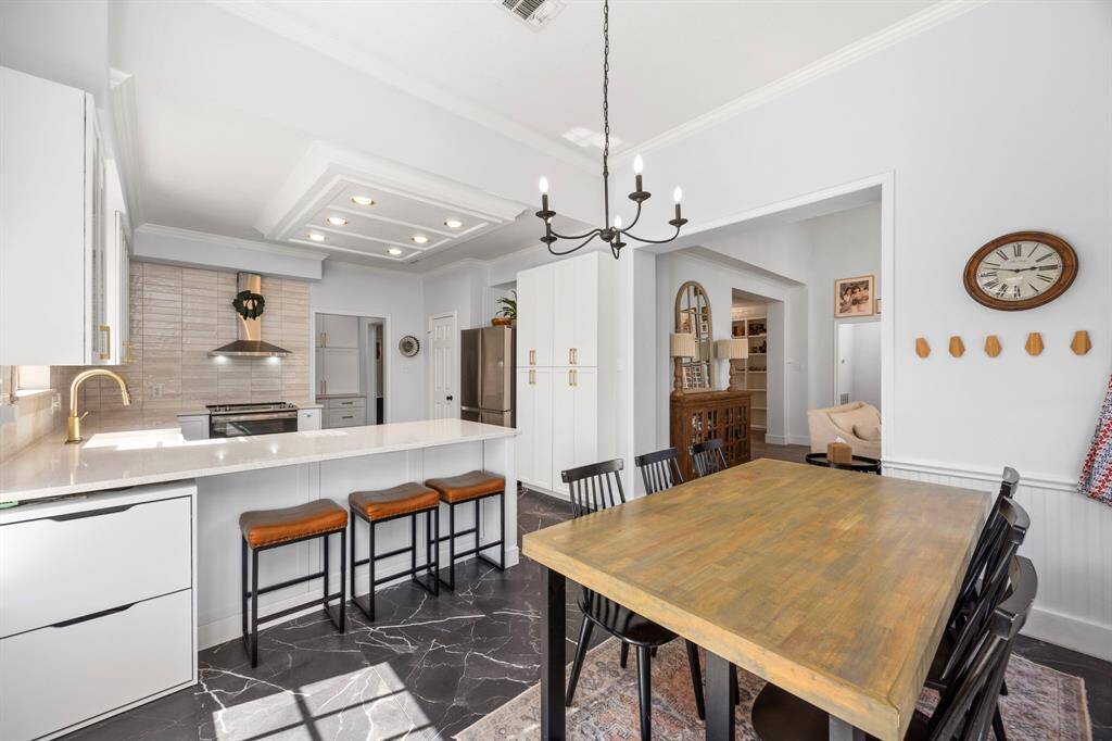 Breakfast nook is surrounded by windows flooded with natural light.