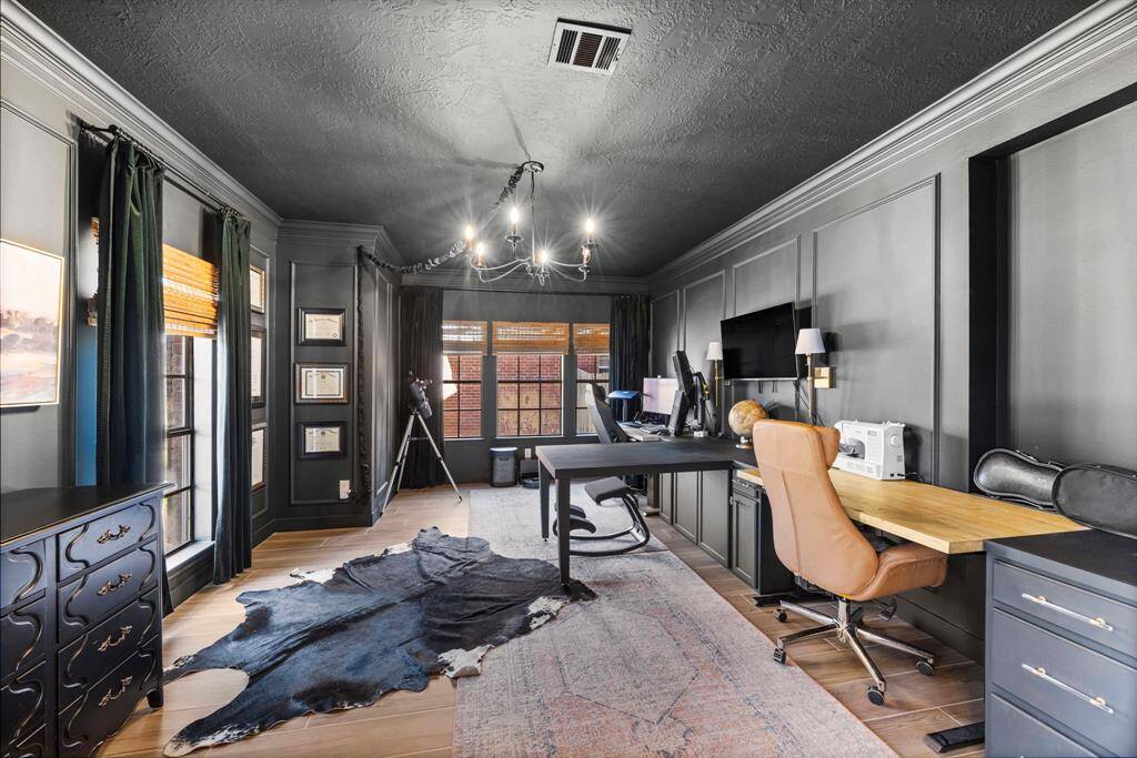 A view towards the front door showcases custom built-ins for a home library.