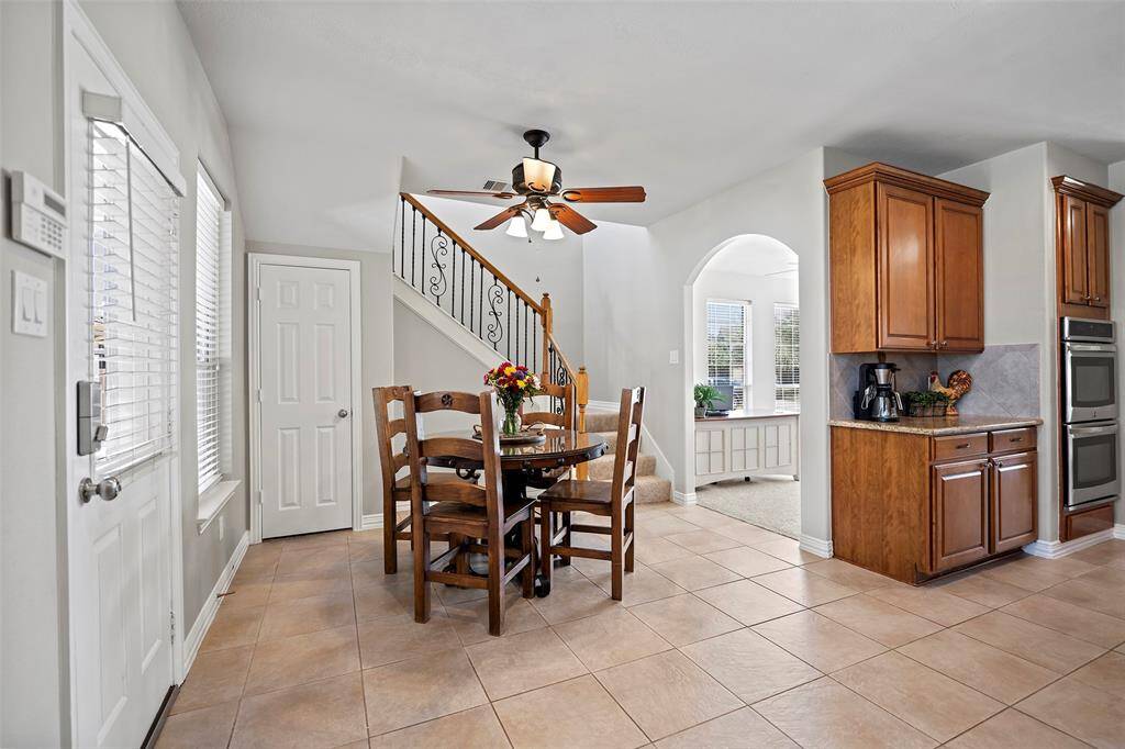 As we enter the kitchen, you will note a charming breakfast nook, ideal for morning meals or late night homework sessions!