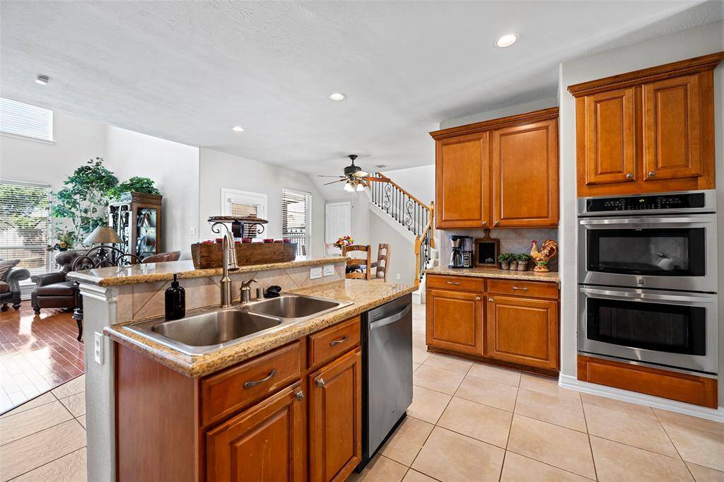 A stainless sink with pull down faucet/spray nozzle helps with the task of doing dishes!