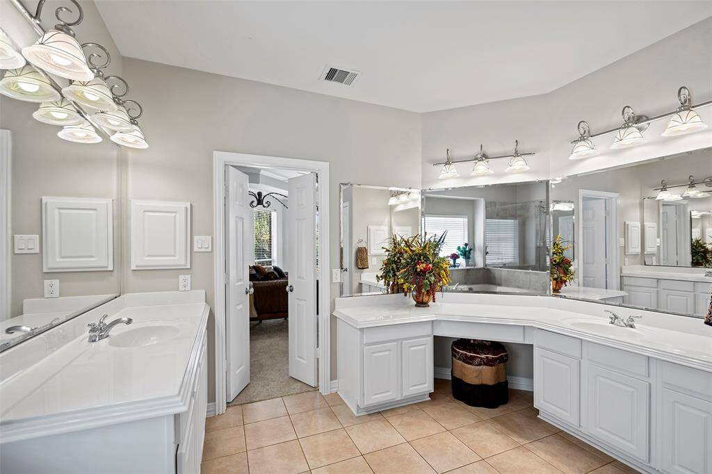 This bathroom features two vanities with separate sinks, drawers and cabinets for storage!  One has knee space so you can take your time to mentally prepare for your day!
