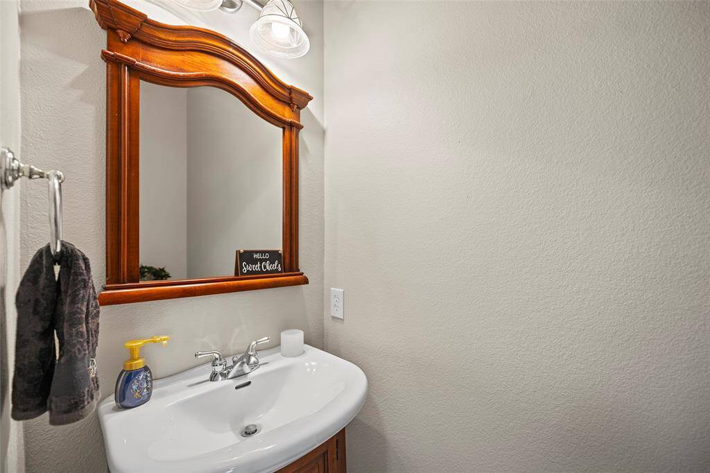 A quaint powder room stands ready for your guests to fresh up during a visit.