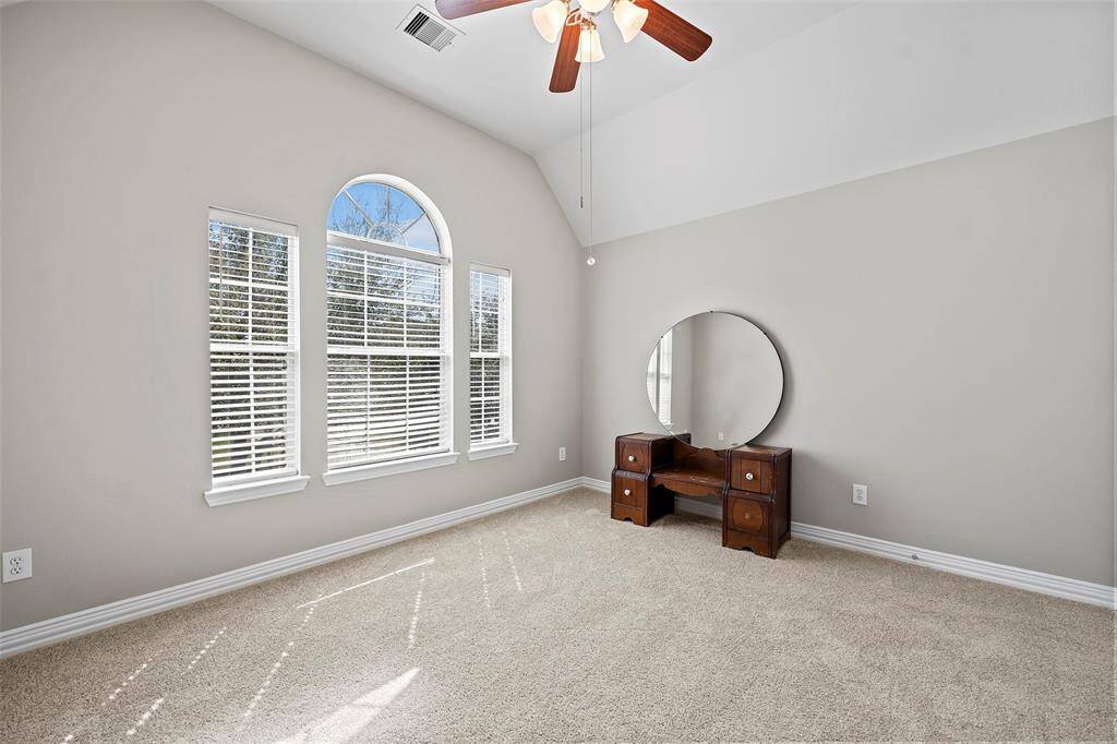 This home boast 4 secondary bedrooms, each with their own character and charm!  We love the half-moon window perched above this set of windows!