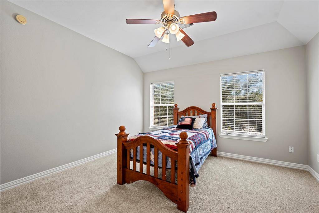 This spacious bedroom with charming windows, neutral tones and soft carpet!
