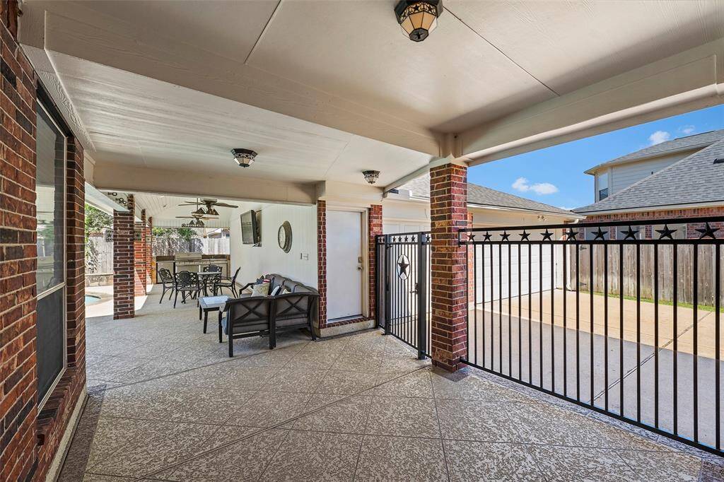Step outside onto the covered patio and start your adventure into your own backyard oasis!  The breezeway is adorned with an iron fence for added security and leads to the garage, so the task of getting groceries to the house in the rain won't be as problematic!