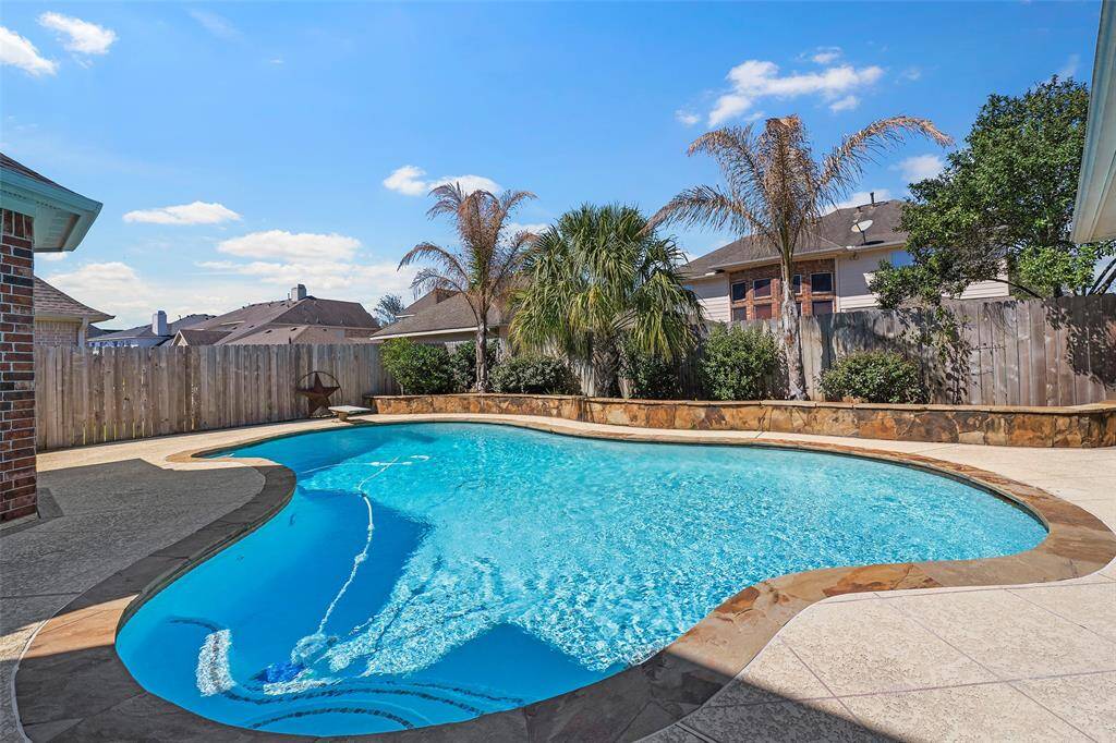 And here is that sparkling pool we all dream of! And the added feature of the raised wall with landscaping provides additional seating for backyard parties!