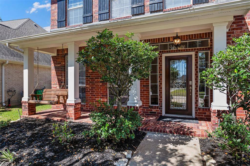 A welcoming front porch tucked behind the lush landscaping offers a place to relax and wave to the neighbors when they walk by or enjoying a morning cup of coffee listening to the birds chirp in the spring air!
