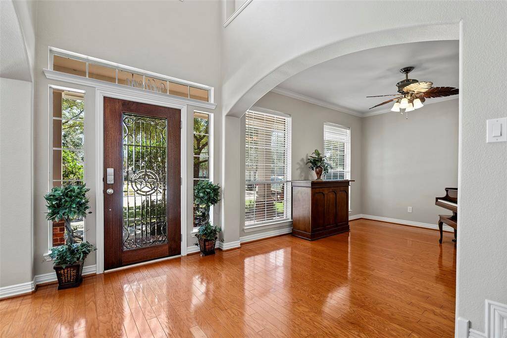 The natural light that bellows into the front entry and formal spaces is magnificent!  From the 2-story ceilings, the gorgeous leaded glass door with sidelight windows and large picture windows, all glistening onto the hardwood floors!