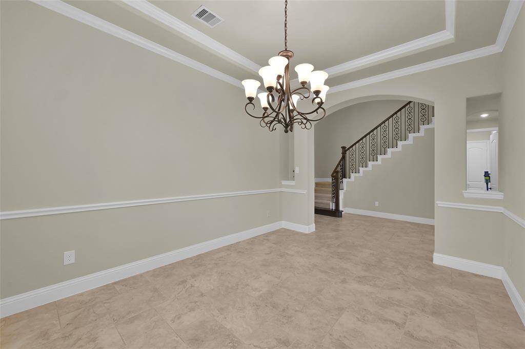 Bathed in natural light and luxury design elements from tray ceilings, crown molding, chair molding, this space will not disappoint in comfortably accommodating grand furniture!