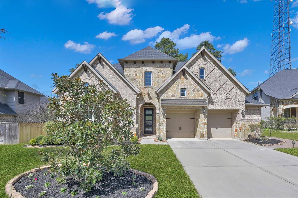 Lush landscape, charming stone and brick elevation double driveway on a cul-de-sac greets you as soon as you drive up!