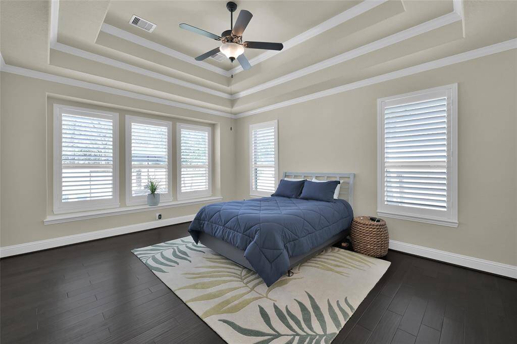 A true escape to your own private retreat-the Primary Suite! Stunning tray ceiling design and crown molding, shutters, beautiful wood flooring and LOADS of space for your large furnishings!