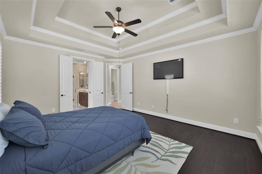 This gives you another view of the Primary Suite and the French doors leading to your ensuite. Mounted TV remains with home.