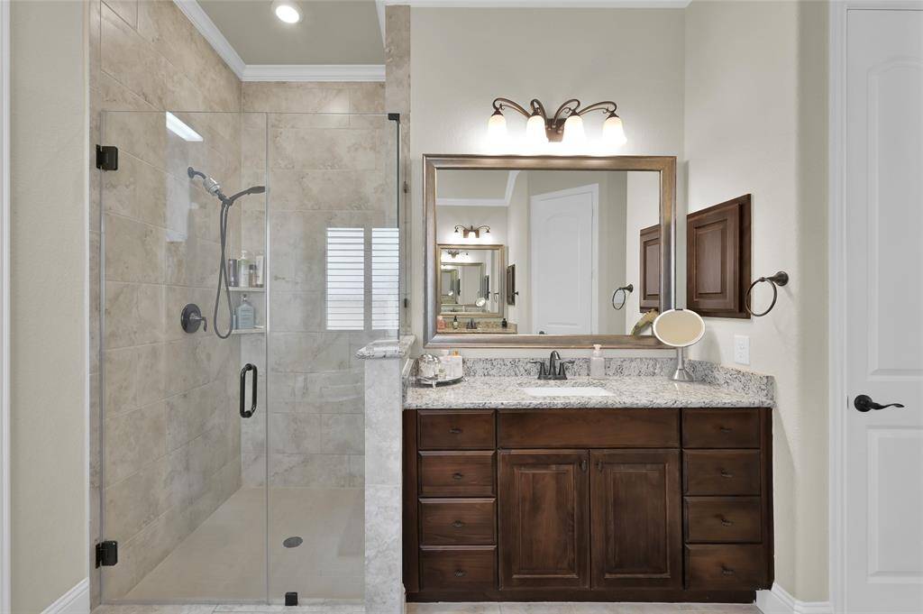 Frameless glass shower and tiled all the way to the ceiling, this is the perfect setting to get ready each day!