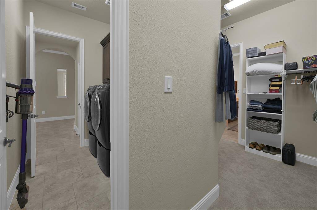 HUGE Primary Bedroom closet attaches to laundry/utility room. How convenient!