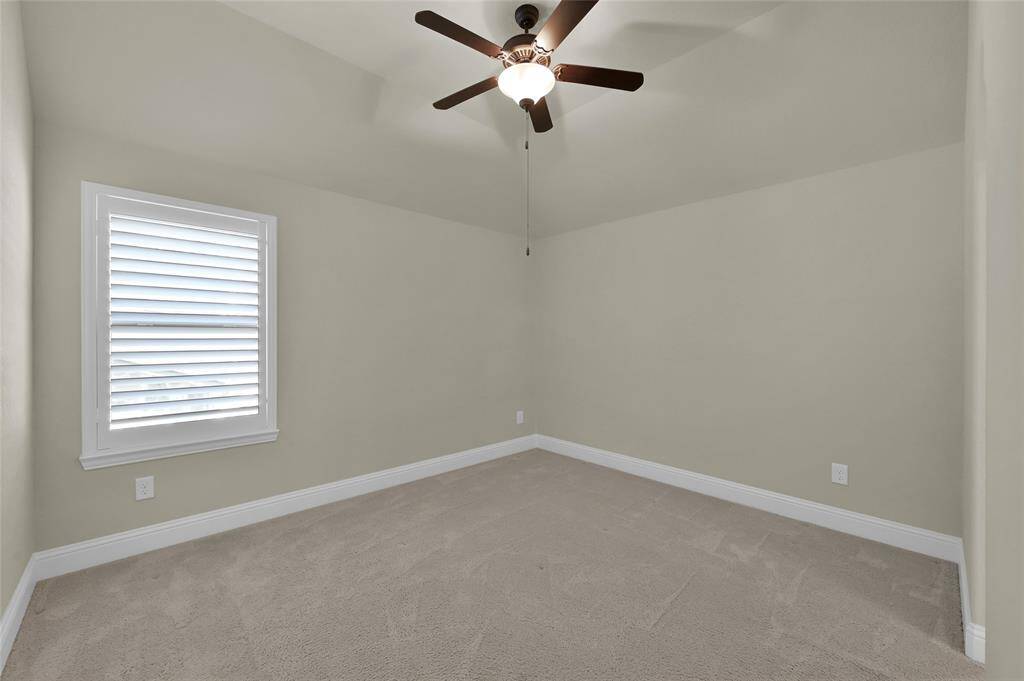 One of two upstairs secondary bedrooms with ceiling fans, carpet, and GREAT closet space!