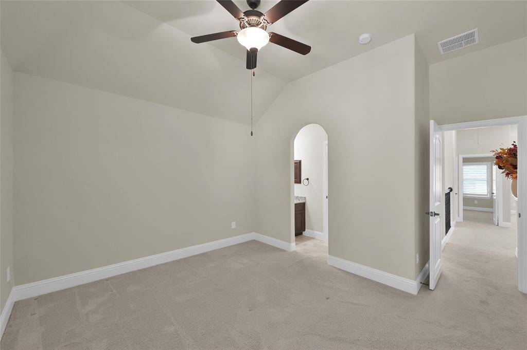 The 2nd of the upstairs secondary bedrooms with convenient access to the bathroom through the arch entry.